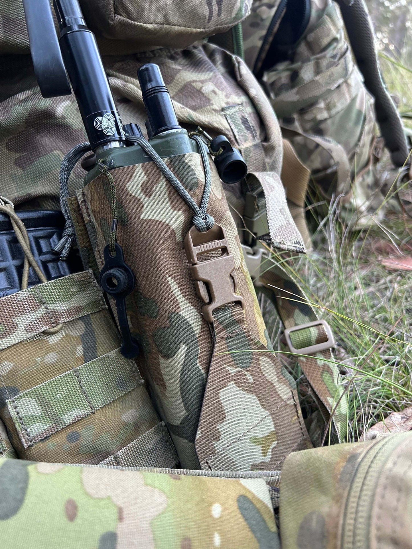 Camouflage precision-fit radio pouch for AN/PRC-152 in tactical gear setup.