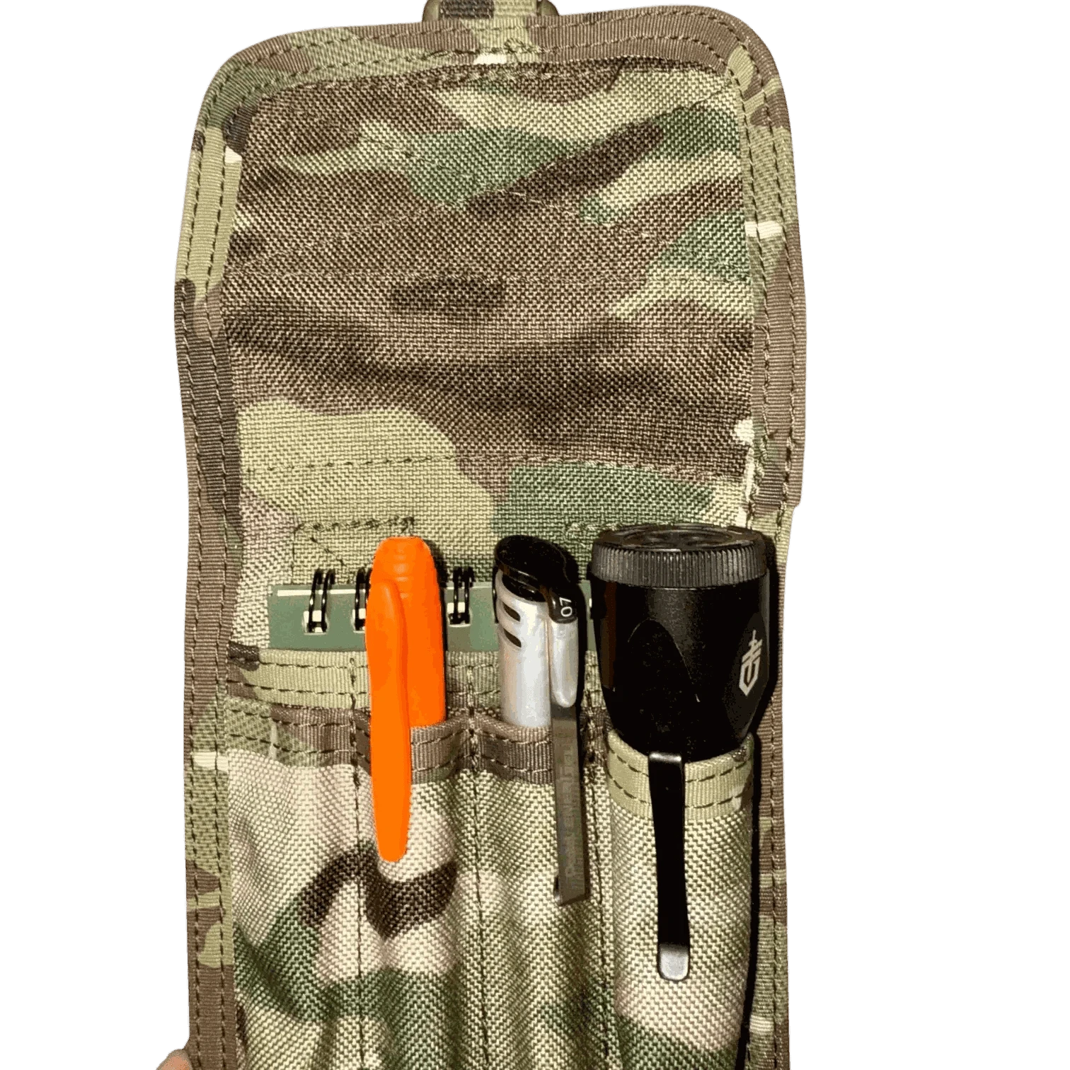 Pen pouch with MOLLE compatibility holding pens and tools, featuring camouflage fabric for tactical use.