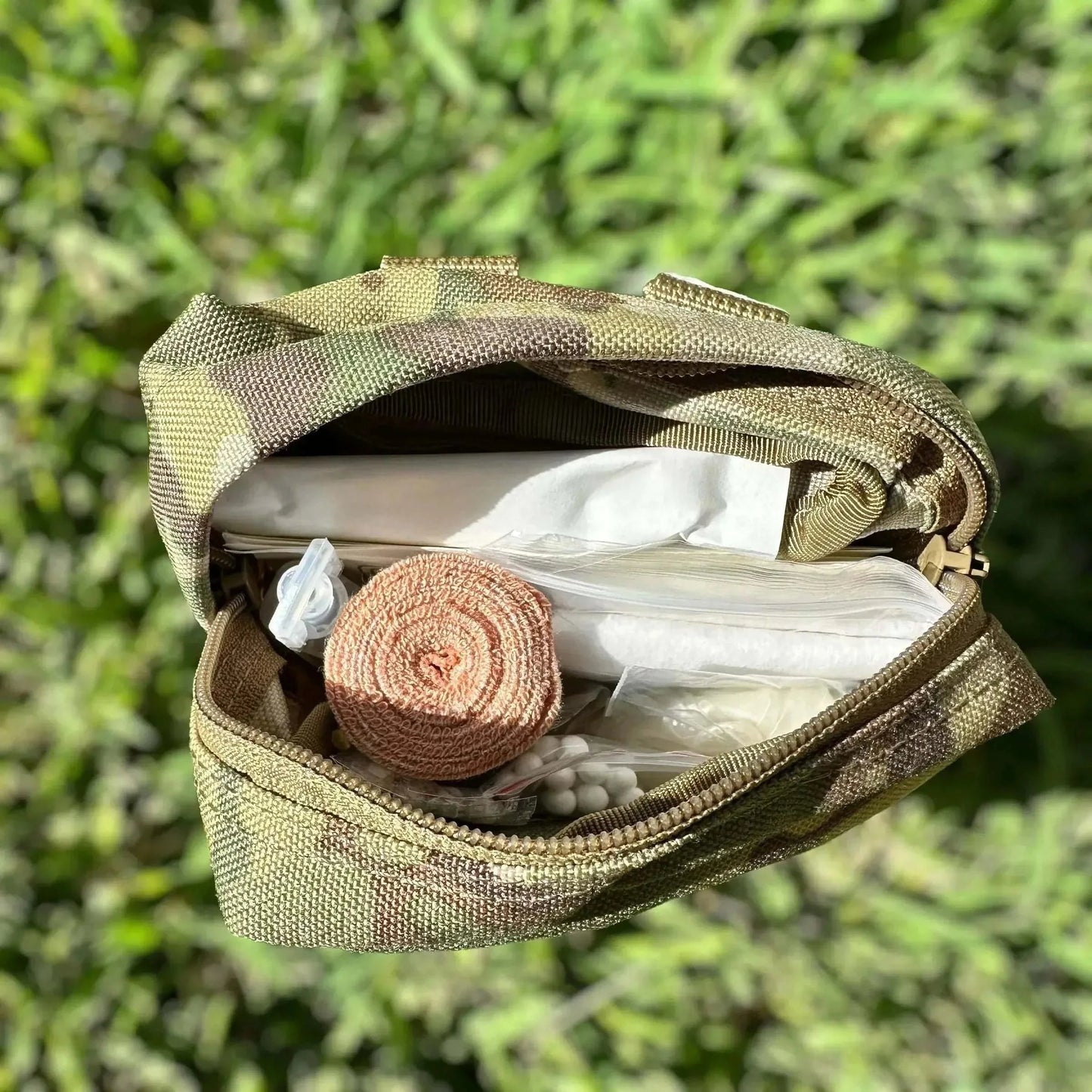 Tactical First Aid Kit with medical supplies in durable military-grade pouch.