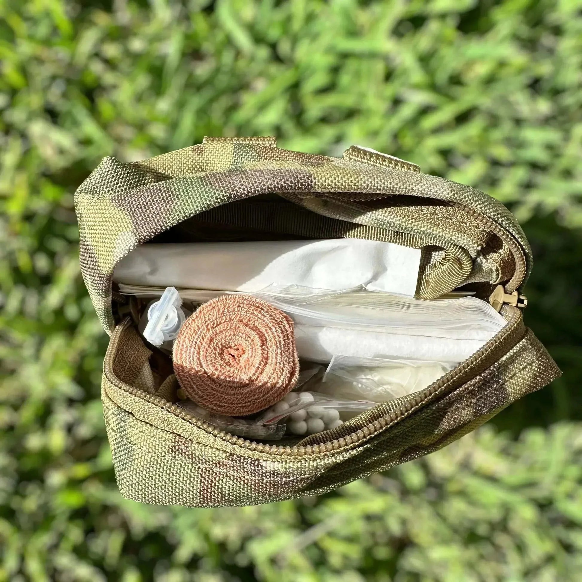 Tactical First Aid Kit with medical supplies in durable military-grade pouch.