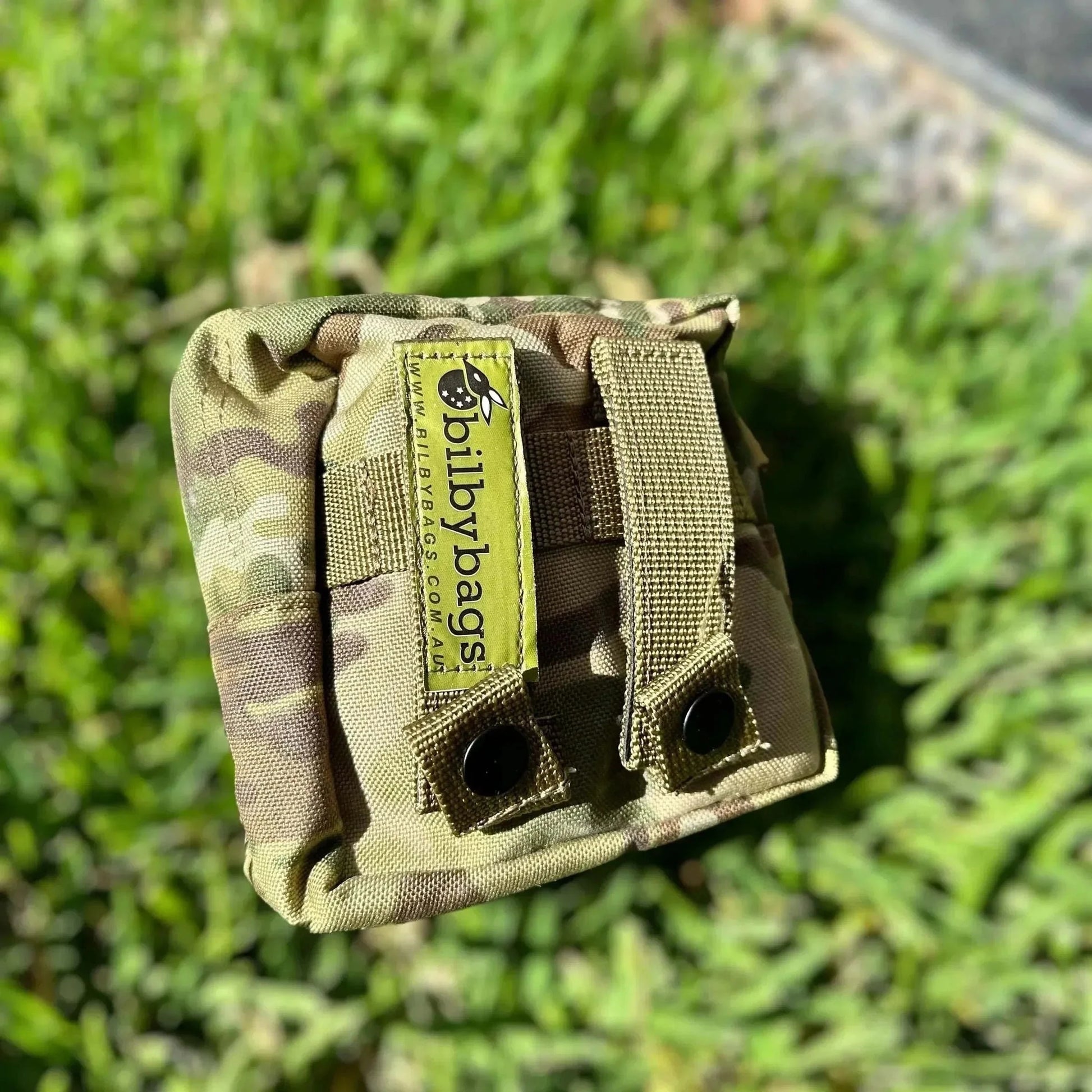 Tactical First Aid Kit in a durable, military-grade Multicam pouch on grass background.