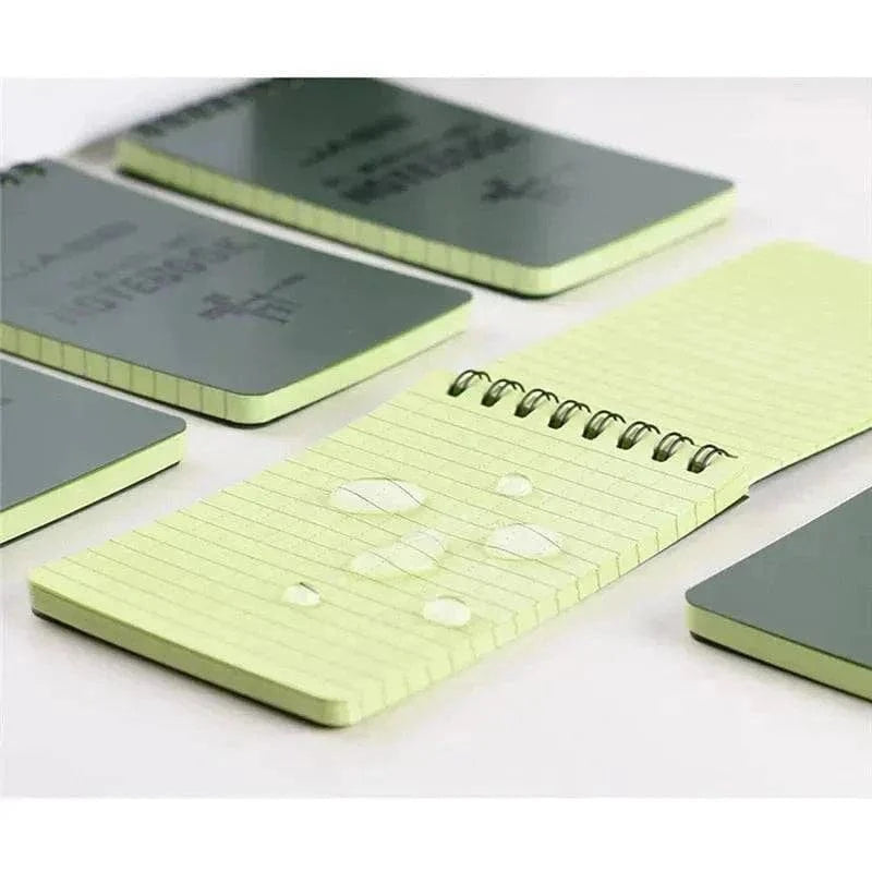 Waterproof notebooks with raindrops highlighting water-resistant pages, ideal for outdoor adventures and daily notes.