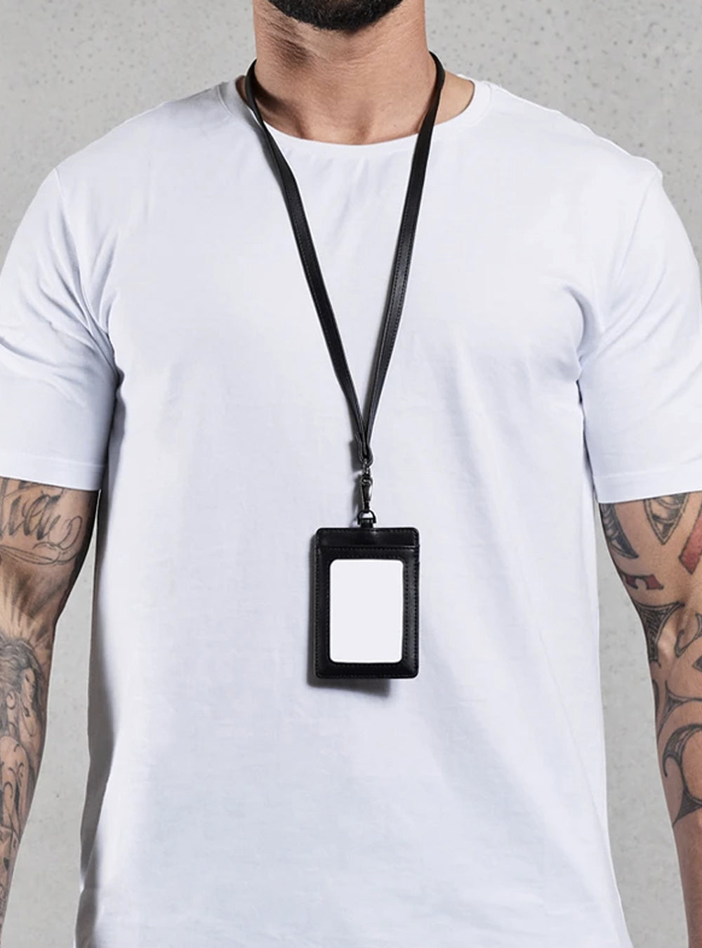 TacSource Leather ID Holder on lanyard worn by person in white shirt.