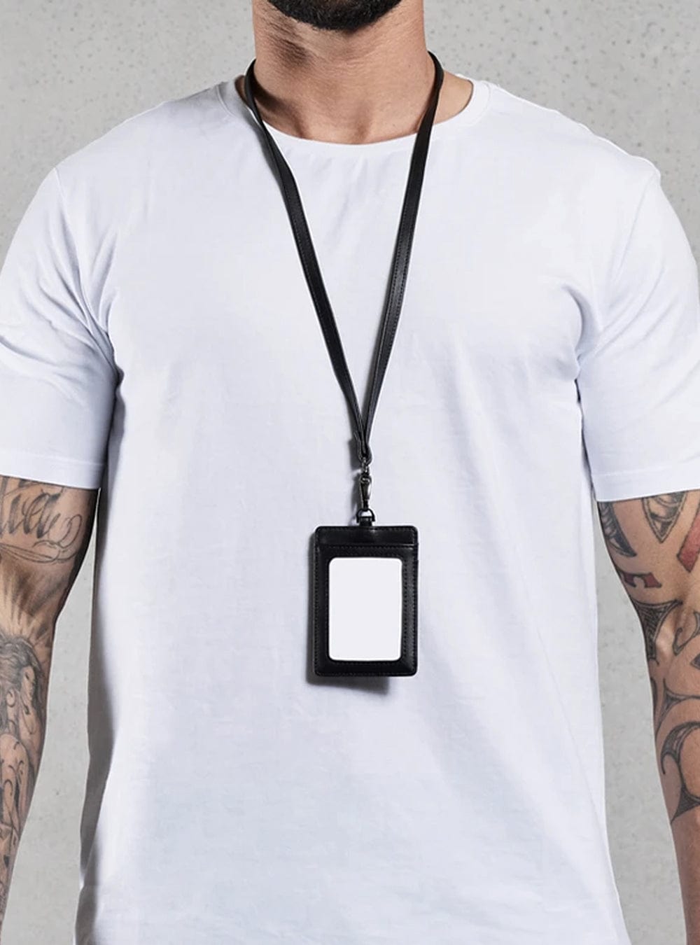 TacSource Leather ID Holder on lanyard worn by person in white shirt.