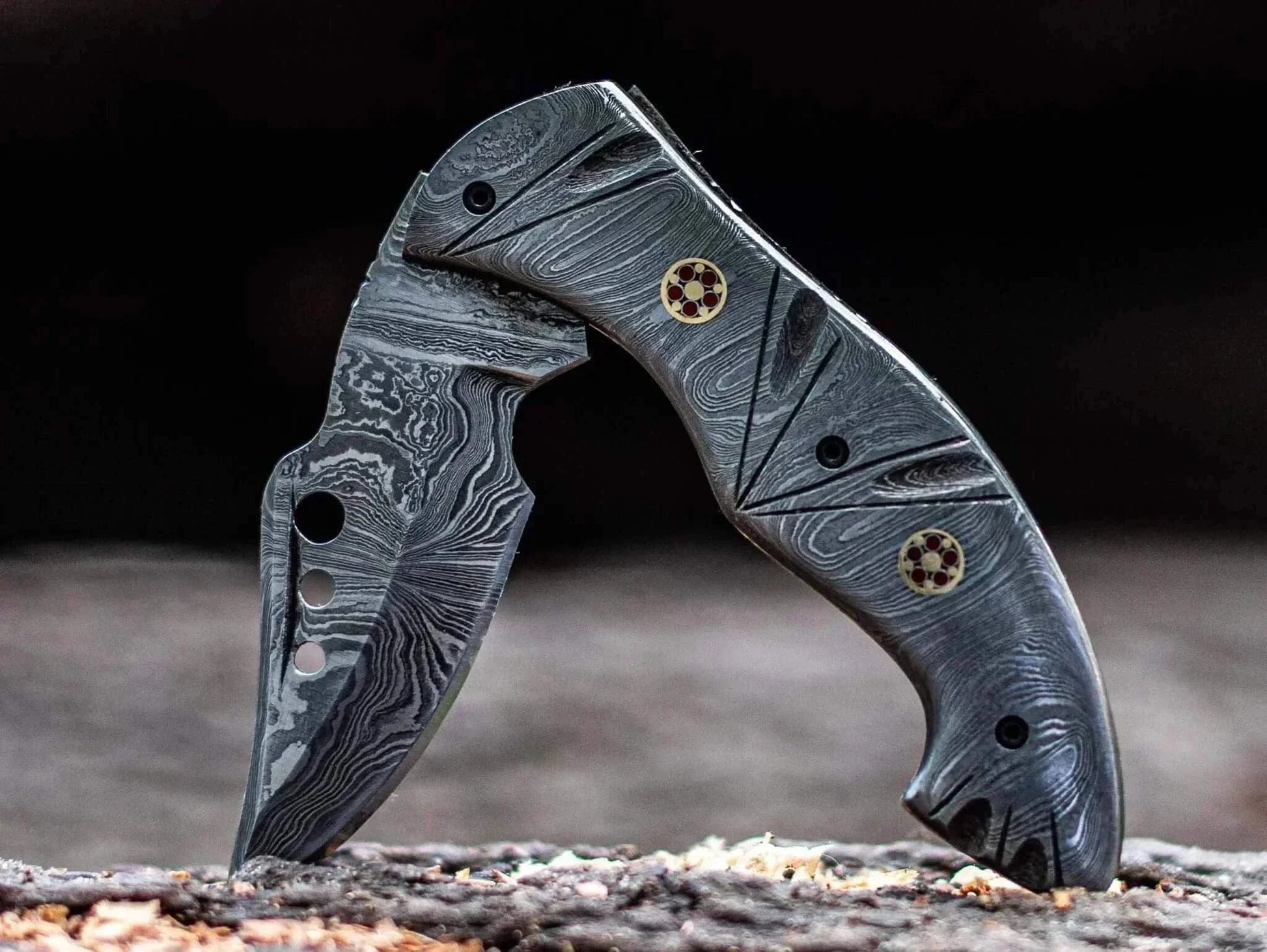Damascus Steel Folding Knife with intricate patterns and robust handle.