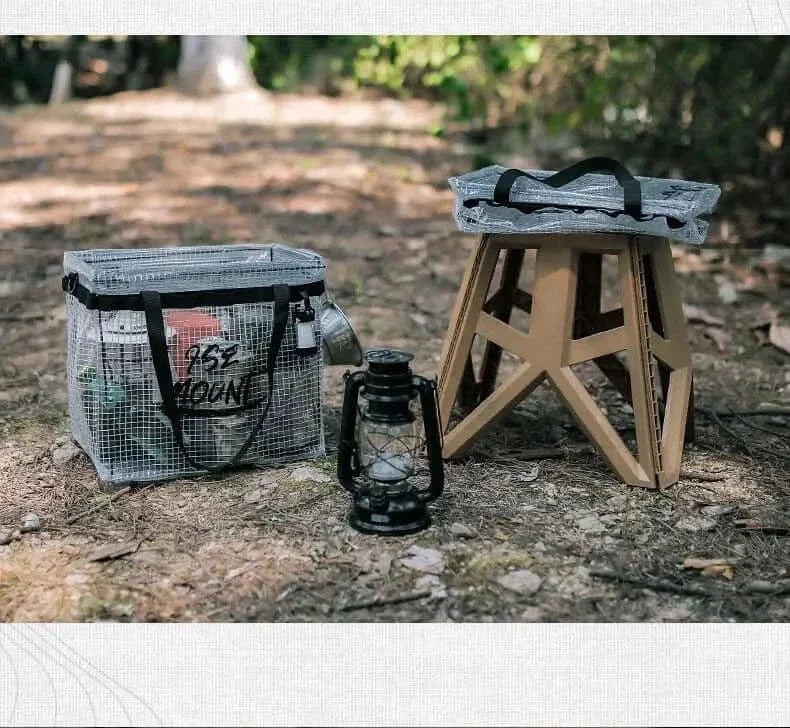 Camping Storage Bag with wooden stool and lantern in forest setting.