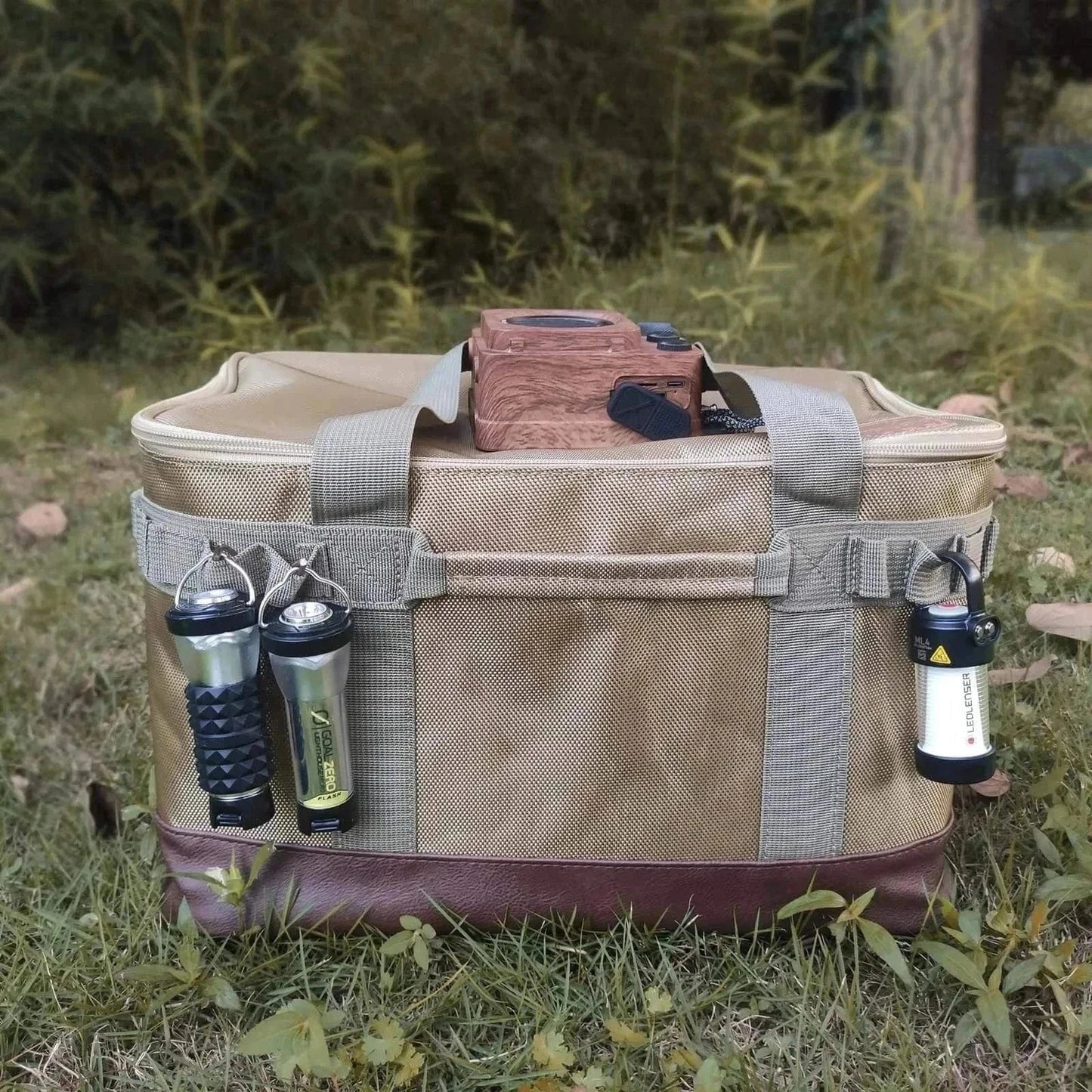 Camping storage bag with multiple hooks on grass background.