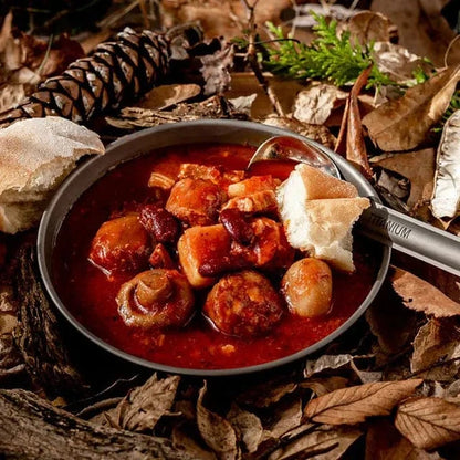 Hearty All Day Breakfast meal with chorizo, bacon, mushrooms, potatoes, and red kidney beans in nature setting.
