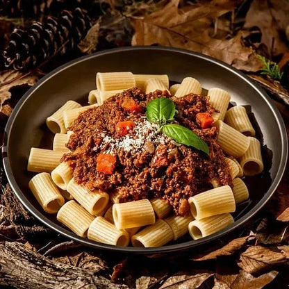 Beef Bolognese served over pasta outdoors, highlighting its suitability for hiking and outdoor adventures.