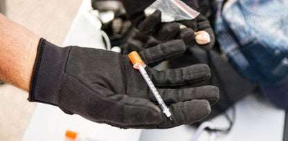 Puncture Pro Hypodermic Needle resistant gloves holding a syringe, showcasing durability and protection for law enforcement and tactical use.