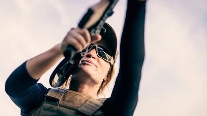 Person wearing Edge Eyewear Hamel shooting glasses with G-15 Vapor Shield while aiming a rifle outdoors.