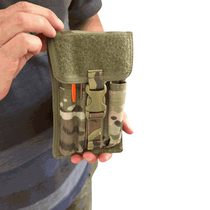 Pen pouch with MOLLE compatibility for tactical and outdoor use, waterproof and durable design, held in hand.