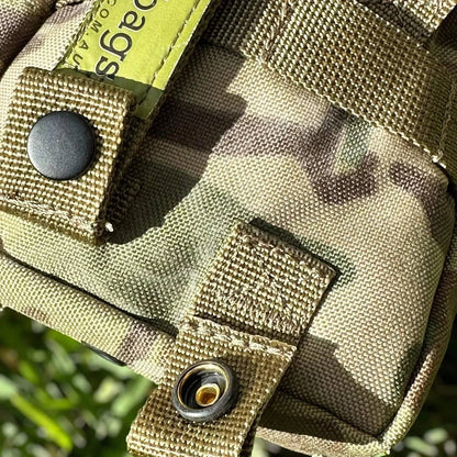 Tactical First Aid Kit in a durable Multicam MOLLE pouch with military-grade fabric and button closure.