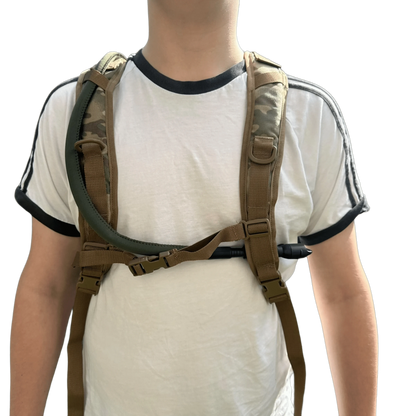 Hydration backpack worn by person, showcasing chest strap and durable design.
