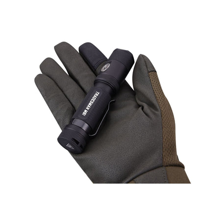 Powertac Tradesman M6-Gen3 flashlight held in gloved hand, compact EDC with 2030 lumens and magnetic tail cap.