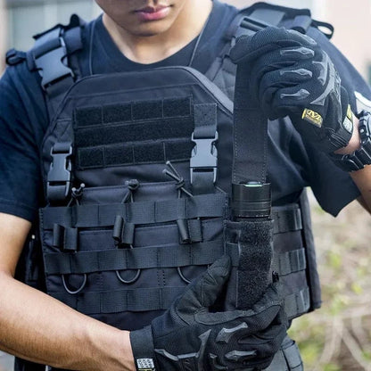 Flashlight holster pouch attached to a tactical vest.