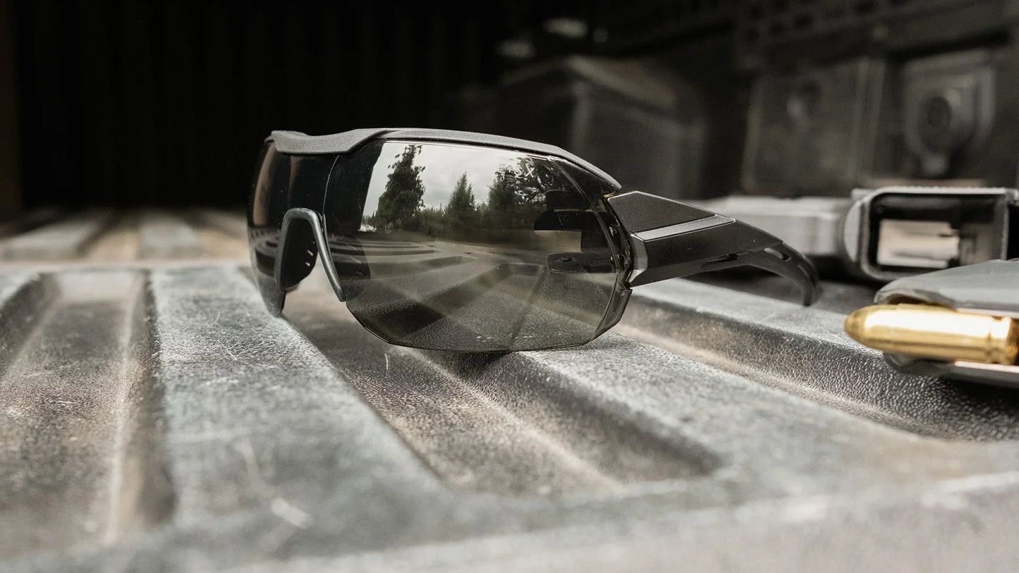 Edge Eyewear Tactical Kabru sunglasses on a textured metal surface, featuring anti-slip frame and Vapor Shield anti-fog technology.