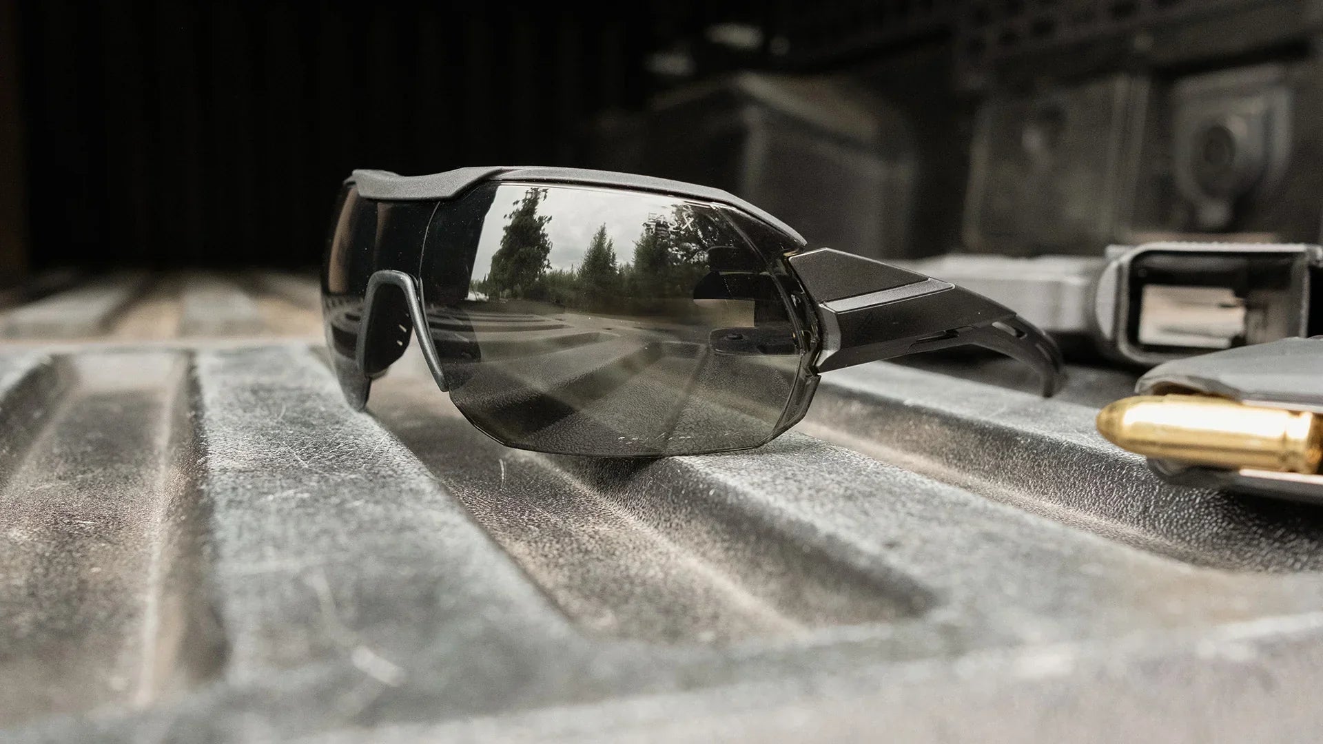 Edge Eyewear Tactical Kabru sunglasses on a textured metal surface, featuring anti-slip frame and Vapor Shield anti-fog technology.