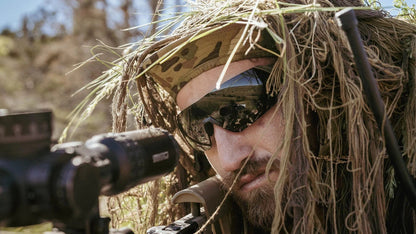 Sniper wearing Edge Eyewear Urgent Fury shooting glasses with camouflage gear.