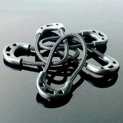 Zipper toggles made of elastic rope and plastic on a reflective surface.