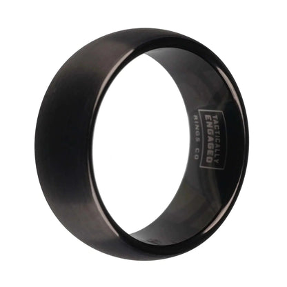 Matte black tungsten ring with engraved interior, showcasing sleek and refined design for strength and style.