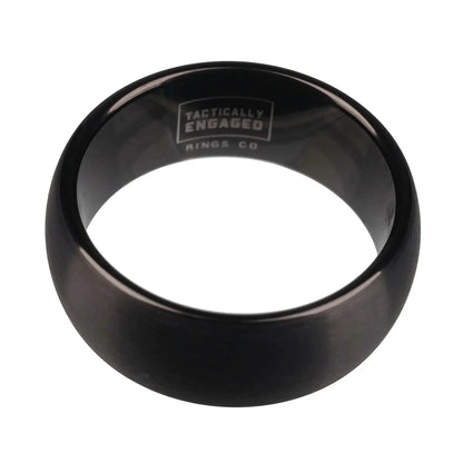 Matte black tungsten ring with "Tactically Engaged" logo inside, showcasing sleek design and durability.