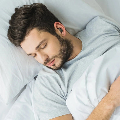 Man sleeping with Axil X20 Earplugs for noise protection.