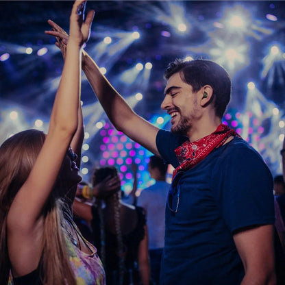 Concertgoer wearing Axil X20 Earplugs for noise protection.