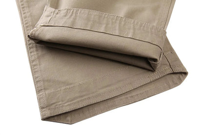 Tan tactical pants for men with durable canvas fabric, showcasing folded hem and rugged design.