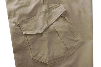 Midweight tactical pants for men with multiple pockets, made from durable canvas fabric, perfect for outdoor activities.