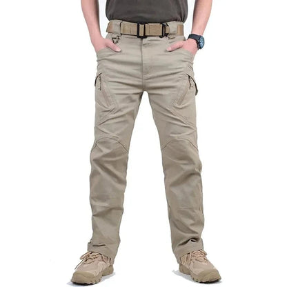 Men's tactical pants in beige with multiple pockets and rugged design.