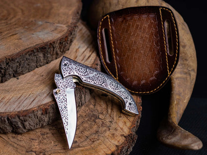 Engraved stainless steel folding knife with leather sheath, premium lockback utility knife.