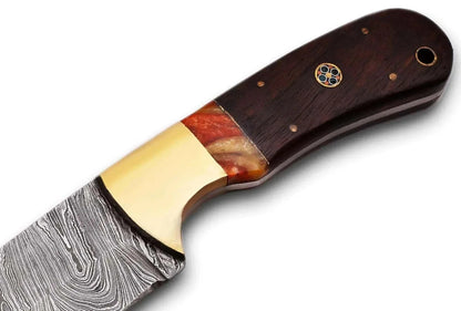 Close-up of a handcrafted Damascus Steel Hunting Knife handle with intricate patterns and brass bolster.