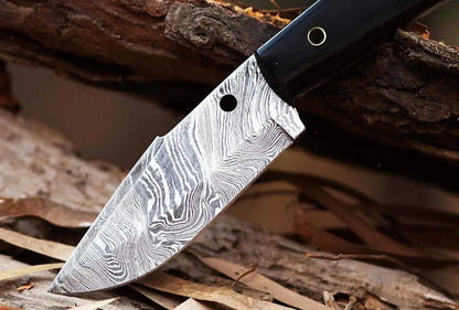Damascus Steel Hunting Knife with pattern welded blade and black handle, handmade for hunting and skinning.