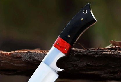 High Carbon Steel Hunting Knife with bull horn and pakka wood handle, designed for skinning, resting on wood.