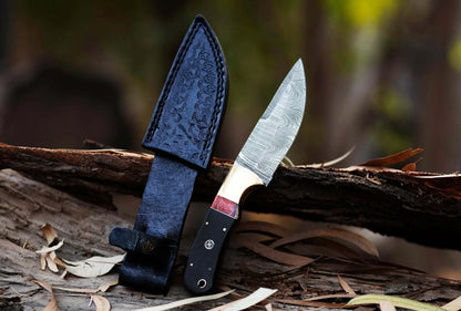 Damascus Steel Hunting Knife with leather sheath, hand-forged blade, and Pakka Wood handle.