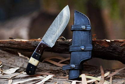 Damascus Steel Hunting Knife with Pakka Wood handle and leather sheath on rustic wood background.