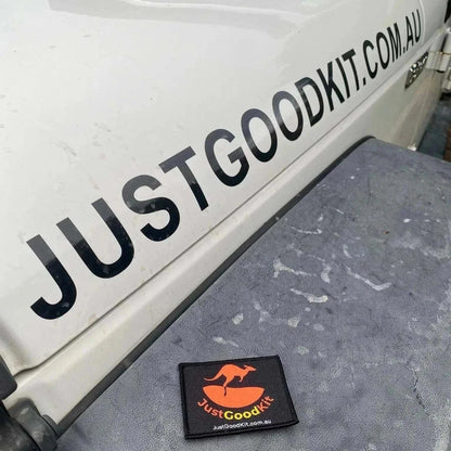 JustGoodKit Morale Patch with Velcro hook, displayed on outdoor surface.
