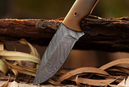 Damascus Steel Hunting Knife with patterned blade and bull white horn handle.