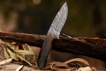 Damascus Steel Hunting Knife with pattern welded blade and bull white horn handle, ideal for skinning and hunting tasks.