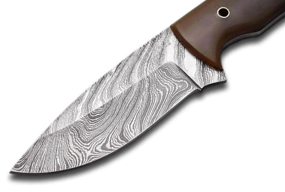 Damascus Steel Hunting Knife with bull white horn handle and patterned steel blade.