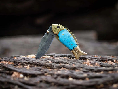 Fish Style Damascus Steel Folding Knife with unique layered patterns, blue handle, and protective leather sheath.