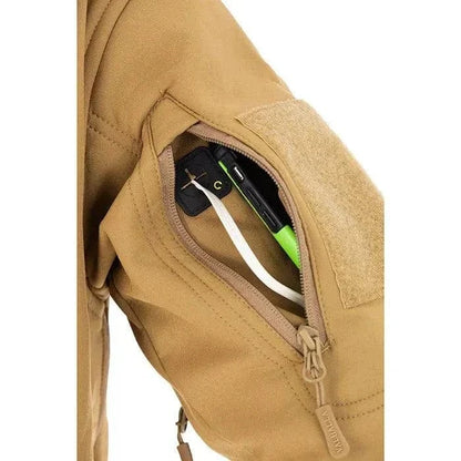 Close-up of the Valhalla Tactical Softshell Jacket's sleeve pocket with headphone port.
