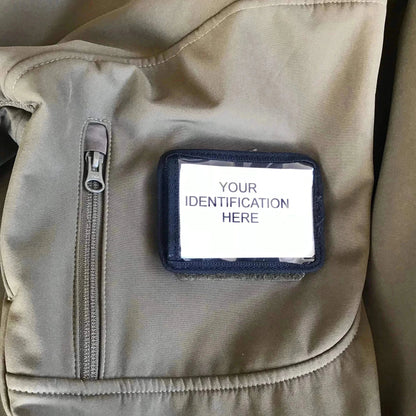 Velcro ID card holder attached to a uniform with a clear window displaying an identification card.