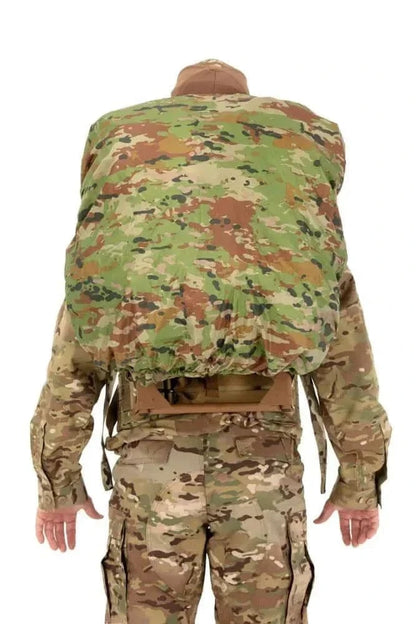 Camouflage backpack rain cover providing waterproof protection in outdoor setting.