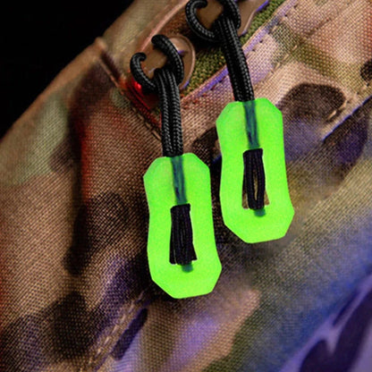 Glow-in-the-dark zipper pulls on a bag for enhanced visibility and safety.