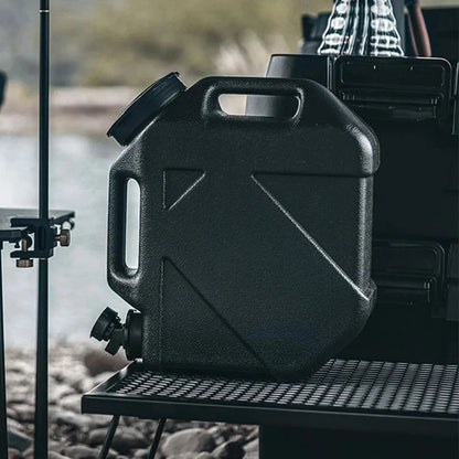 Ultimate Portable Water Container, sleek black, 10L capacity, with detachable tap, on a camping trip.