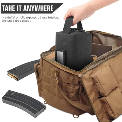 Compact tactical tool bag being placed in a larger duffel bag, highlighting portability and organization for outdoor use.