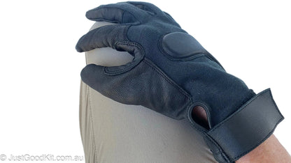 Tactical glove made of Kevlar and aniline goatskin with Velcro cuff, worn for protection and comfort.
