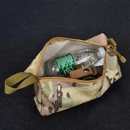 Camouflage EDC organiser with zipper open, holding everyday carry items.